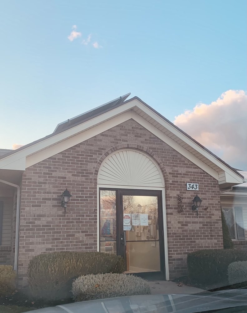 The brick exterior of the Caring For Cats clinic at golden hour