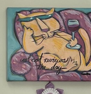A whimsical painting of a lounging cat reading reviews