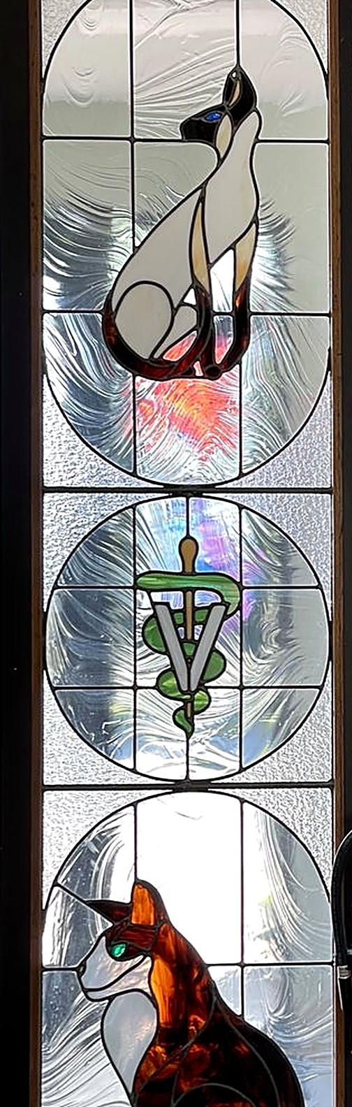 Detail of the clinic's stained glass cat panel
